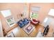 Open-concept living room with vaulted ceilings, large windows, hardwood floors, and cozy seating at 220 Holmes Ct, Concord, NC 28027