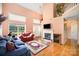 A well-lit living area with fireplace, hardwood floors, and staircase, creating a cozy and inviting space at 220 Holmes Ct, Concord, NC 28027