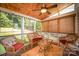 Inviting screened porch features wood ceiling, wicker furniture, ceiling fan, and large windows with a lush green view at 220 Holmes Ct, Concord, NC 28027