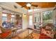 Cozy screened porch features wood ceiling, wicker furniture, and sliding door to the interior at 220 Holmes Ct, Concord, NC 28027