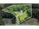 Aerial view of a property, highlighting the home's location and lot boundaries within a forested area at 220 Plonk Rd, Dallas, NC 28034