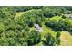 Expansive property featuring a charming home nestled within lush greenery and mature trees at 220 Plonk Rd, Dallas, NC 28034