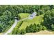 Aerial view of a home and its surroundings, featuring well-maintained landscaping and a long driveway at 220 Plonk Rd, Dallas, NC 28034