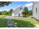 Backyard with a detached garage, stone walkway, and well-maintained lawn, offering privacy at 220 Plonk Rd, Dallas, NC 28034