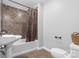 Bathroom with a tile surround tub, pedestal sink, and toilet with decorative touches at 220 Plonk Rd, Dallas, NC 28034