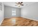 Bedroom featuring wood floors, a ceiling fan, and a window providing natural light at 220 Plonk Rd, Dallas, NC 28034