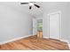 Bedroom with hardwood floors, closet, ceiling fan, and an open door to another room at 220 Plonk Rd, Dallas, NC 28034