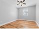 Bedroom featuring hardwood floors, neutral paint, ceiling fan, and a window at 220 Plonk Rd, Dallas, NC 28034