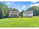 Daytime view of a home featuring a welcoming front porch and a detached garage at 220 Plonk Rd, Dallas, NC 28034