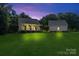 Charming exterior of a well-maintained home with a large yard and separate garage at 220 Plonk Rd, Dallas, NC 28034
