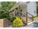 Inviting front porch with wood railings and steps, perfect for relaxing outdoors at 220 Plonk Rd, Dallas, NC 28034