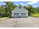 Detached two-car garage with paved driveway, enhancing curb appeal and functionality at 220 Plonk Rd, Dallas, NC 28034
