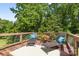 Decking with lounging chairs, outside decorative pot, and lush green surroundings at 220 Plonk Rd, Dallas, NC 28034