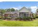 A brick home with a screened in porch and deck with manicured shrubbery at 2241 Flagstick Dr, Matthews, NC 28104
