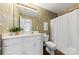Bathroom featuring floral wallpaper, white cabinets, and a shower with curtain at 2241 Flagstick Dr, Matthews, NC 28104