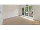 Cozy bedroom with neutral carpet, large window, and ample natural light at 2241 Flagstick Dr, Matthews, NC 28104