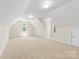 Spacious carpeted bonus room with neutral paint and ample natural light from the arched windows at 2241 Flagstick Dr, Matthews, NC 28104