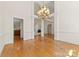 Elegant dining room boasts wood floors, a grand chandelier, and archways for an open, airy feel at 2241 Flagstick Dr, Matthews, NC 28104