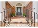 Elegant brick entryway with decorative railing and beautiful front door at 2241 Flagstick Dr, Matthews, NC 28104