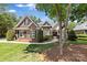 Beautiful brick home with a well-manicured lawn and lush, mature landscaping at 2241 Flagstick Dr, Matthews, NC 28104