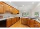 Bright kitchen offers a cooktop, custom cabinets, and a window view to the fenced backyard at 2241 Flagstick Dr, Matthews, NC 28104