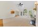 Open floor plan with fireplace, large windows, and neutral carpet at 2241 Flagstick Dr, Matthews, NC 28104