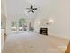 Spacious living room with large windows, fireplace, and neutral carpet at 2241 Flagstick Dr, Matthews, NC 28104