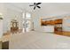 Open-concept living area showcases a fireplace and a view of the foyer and kitchen area at 2241 Flagstick Dr, Matthews, NC 28104