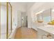 Bright main bathroom features tile floor, white cabinets, and tub with shower at 2241 Flagstick Dr, Matthews, NC 28104