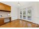 Bright home office area featuring custom built-ins and French doors leading to the screened porch at 2241 Flagstick Dr, Matthews, NC 28104
