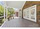 Inviting screened porch with brick accents offers an ideal space for outdoor relaxation and entertainment at 2241 Flagstick Dr, Matthews, NC 28104