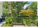 Relaxing balcony with green park views, lush plants, and comfortable seating area at 229 N Church St # 401, Charlotte, NC 28202