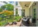 Inviting brick balcony with beautiful garden view, outdoor seating, and ceiling fan at 229 N Church St # 401, Charlotte, NC 28202