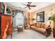 Well-lit bedroom with comfortable seating, unique decor, and a ceiling fan at 229 N Church St # 401, Charlotte, NC 28202