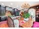 Elegant dining area featuring a chandelier, stylish furniture, and views into the modern kitchen at 229 N Church St # 401, Charlotte, NC 28202