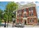Classic brick building featuring elegant architectural details and well-maintained landscaping at 229 N Church St # 401, Charlotte, NC 28202