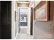 Hallway view shows the gray-painted walls, dark trim, and framed art leading to an en-suite bathroom at 229 N Church St # 401, Charlotte, NC 28202