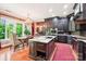 Open-concept kitchen with large island, granite countertops, custom cabinetry, and a dining area at 229 N Church St # 401, Charlotte, NC 28202