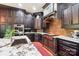 Gourmet kitchen featuring dark wood cabinetry, stainless steel appliances, and granite countertops at 229 N Church St # 401, Charlotte, NC 28202