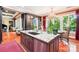Gourmet kitchen featuring an island with sink, stainless appliances, stylish lighting, and adjacent dining area at 229 N Church St # 401, Charlotte, NC 28202