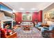 Elegant living room showcasing a fireplace, paintings, comfortable seating, and an ornate rug at 229 N Church St # 401, Charlotte, NC 28202