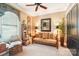 This sitting room features textured walls and a ladder shelving unit next to an arched window at 229 N Church St # 401, Charlotte, NC 28202