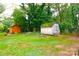 Expansive backyard with lush greenery and mature trees, featuring two sheds and offering ample outdoor space at 238 Deaton St, Statesville, NC 28677
