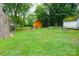 View of the large backyard featuring green grass and mature trees, perfect for outdoor activities at 238 Deaton St, Statesville, NC 28677