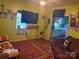Living room with large TV, old AC unit, and patterned rug at 238 Deaton St, Statesville, NC 28677