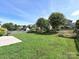 Spacious backyard with manicured lawn and mature trees at 3009 Canopy Dr, Indian Trail, NC 28079