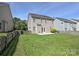 Large, grassy backyard with a wood fence and a partial view of the home at 3009 Canopy Dr, Indian Trail, NC 28079