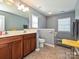 Bright bathroom with double vanity sink, mirror, and tile flooring at 3009 Canopy Dr, Indian Trail, NC 28079
