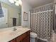 Bright bathroom with vanity, toilet, tub and shower with patterned curtain at 3009 Canopy Dr, Indian Trail, NC 28079