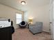 Neutral bedroom with two chairs, a window, and neutral carpet at 3009 Canopy Dr, Indian Trail, NC 28079